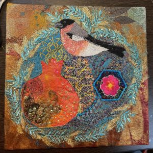 Bullfinch and pomegranate embroidered wall art by Nicky Perryman