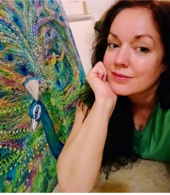 Nicky Perryman Artist with her Peacock embroidery.